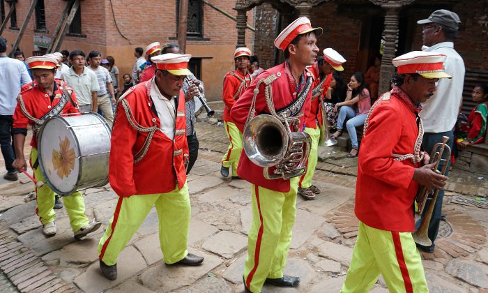 A tired marching band making its way up a street in Bhaktapur.